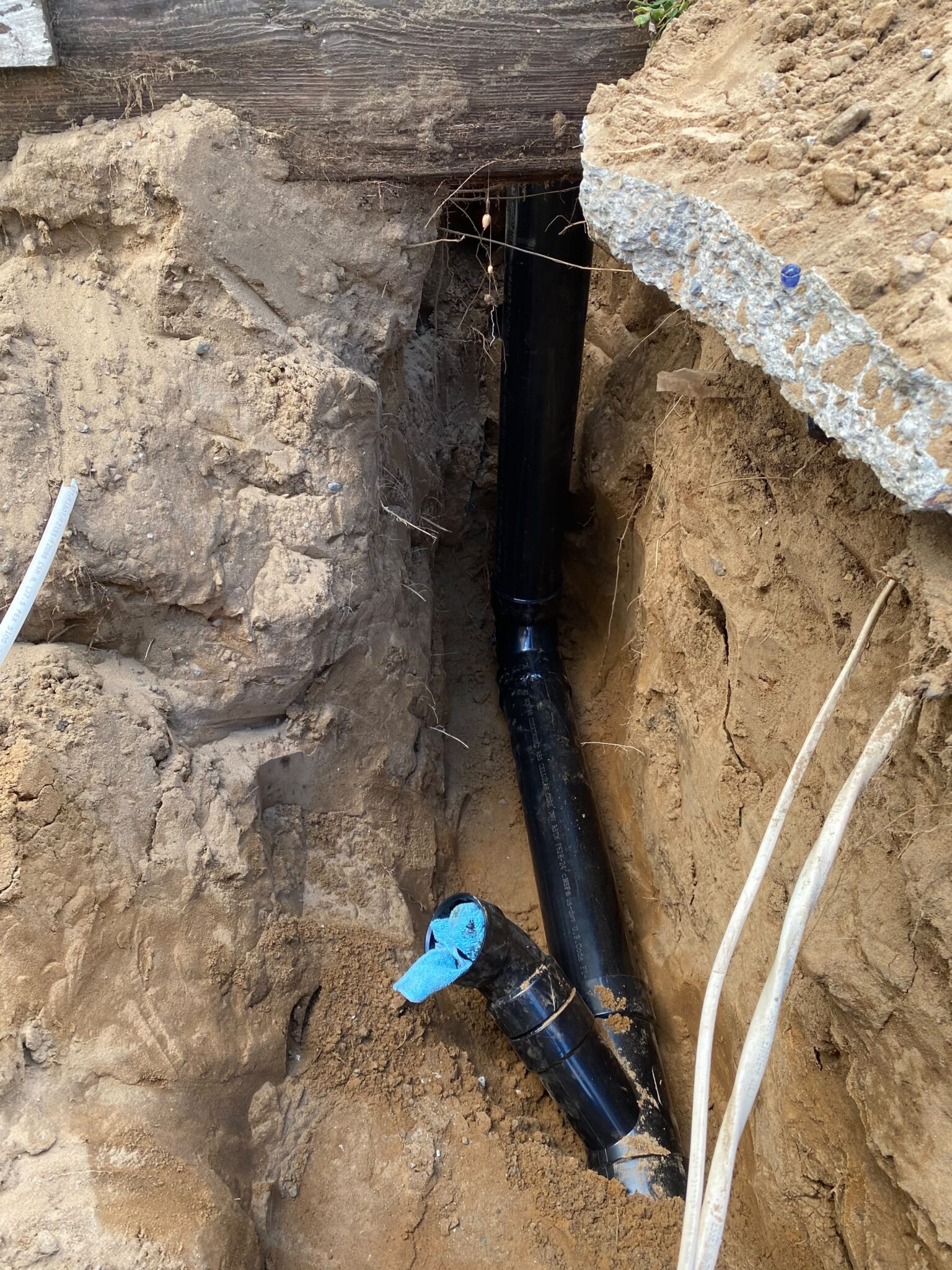Newly installed underground main drain pipe during a professional sewer line repair service in Marina, CA.