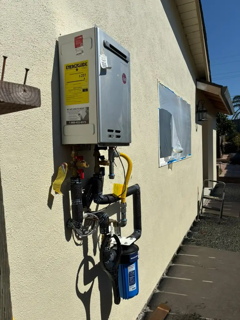 Premium Rheem tankless water heater equipped with a Navien PeakFlow S filtration unit