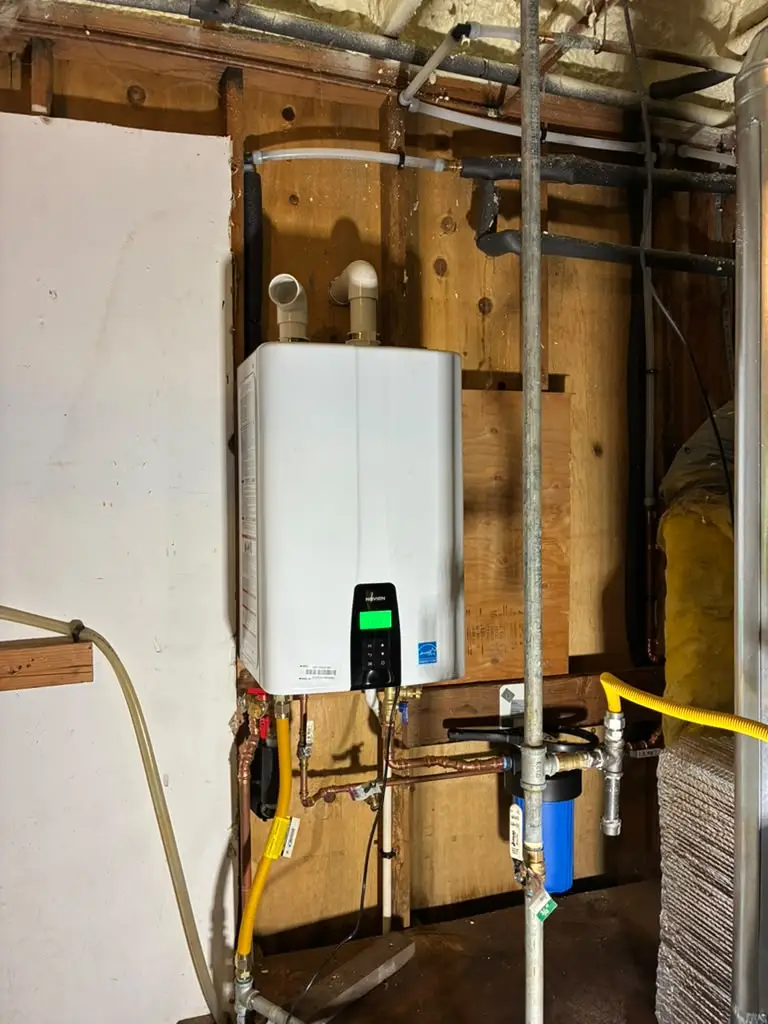 The team at RS Plumbing installed a premium Rheem tankless water heater equipped with a Navien PeakFlow S filtration unit 1
